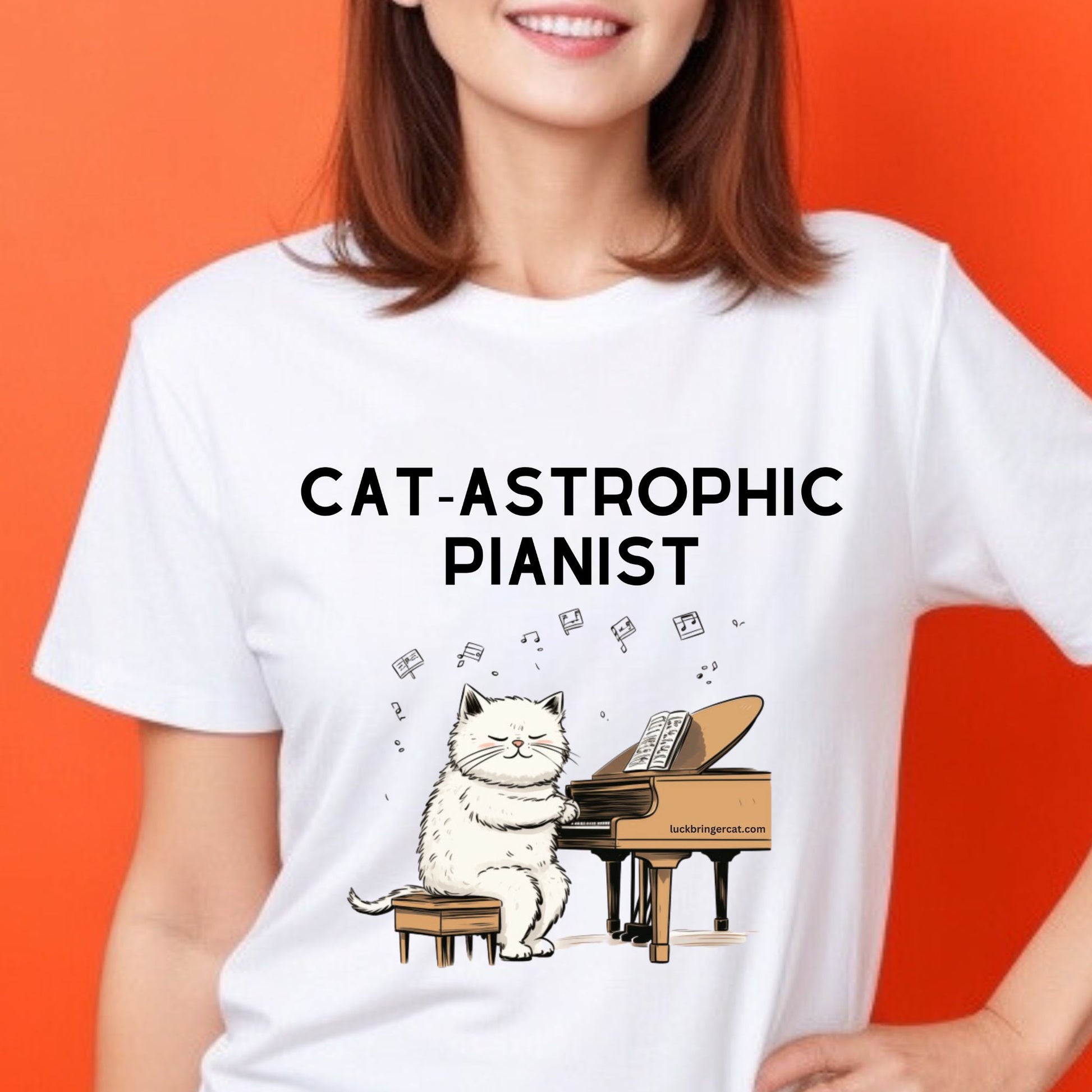 A funny graphic tshirt showing a  cute cat playing piano  and a text above it saying CAT-strophic Pianist